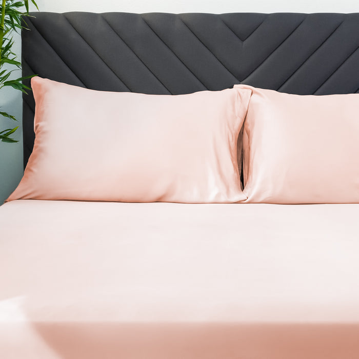 Eco Deluxe Bed Linens 2 Piece Pillowcase Set in peach and cream, shown in a room setting