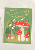 A mushroom and creature print card, text reads "Have A Magical Holiday Season".