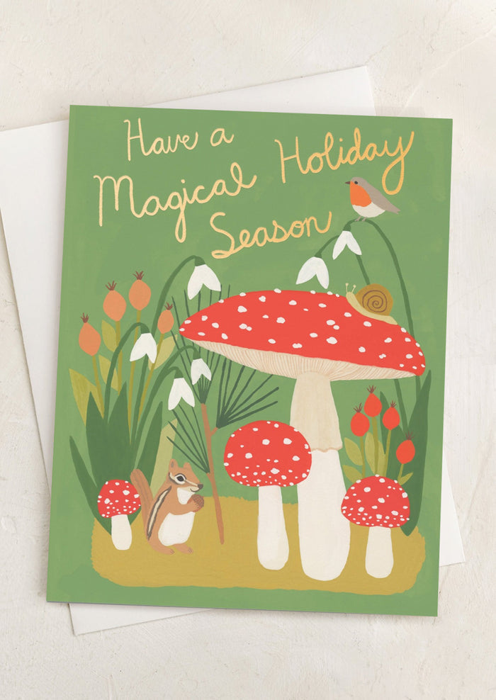 A mushroom and creature print card, text reads "Have A Magical Holiday Season".