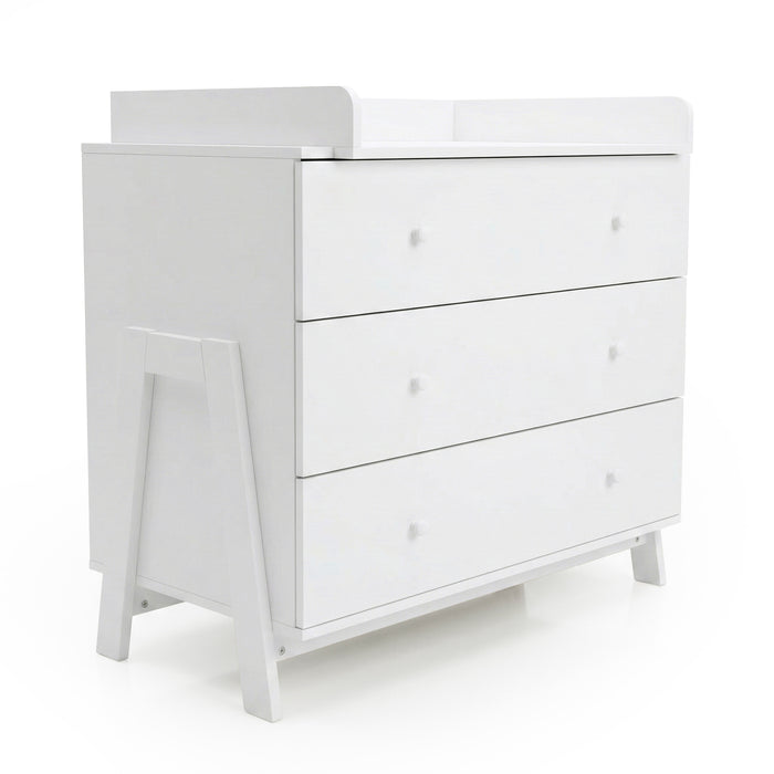 Angled view of white three-drawer dresser with raised changing tray