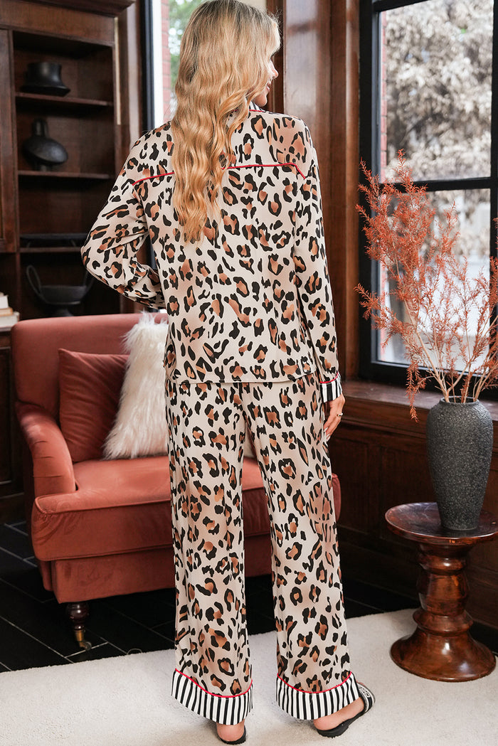 Person wearing a leopard print outfit in a room with a pink sofa and window.