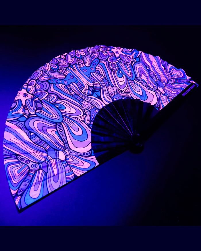 Mind Bender hand fan angled view psychedelic swirl pattern under blacklight.