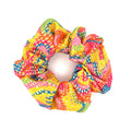 Colorful patterned stash scrunchie on a white background