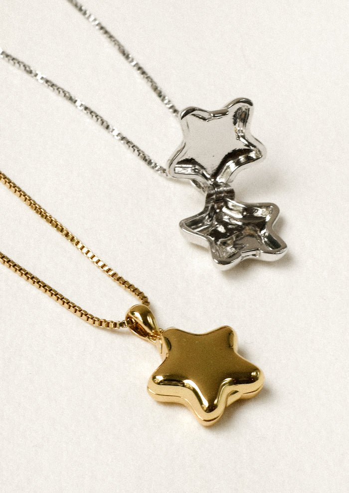 One gold and one silver necklace with a puffy star locket pendant.