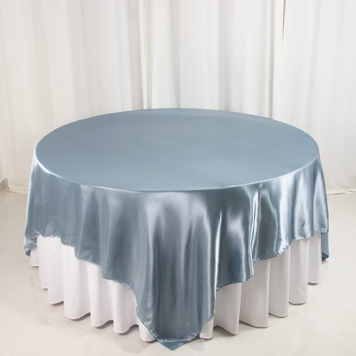 Round satin tablecloth in soft blue on a white table.