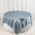 Round satin tablecloth in soft blue on a white table.