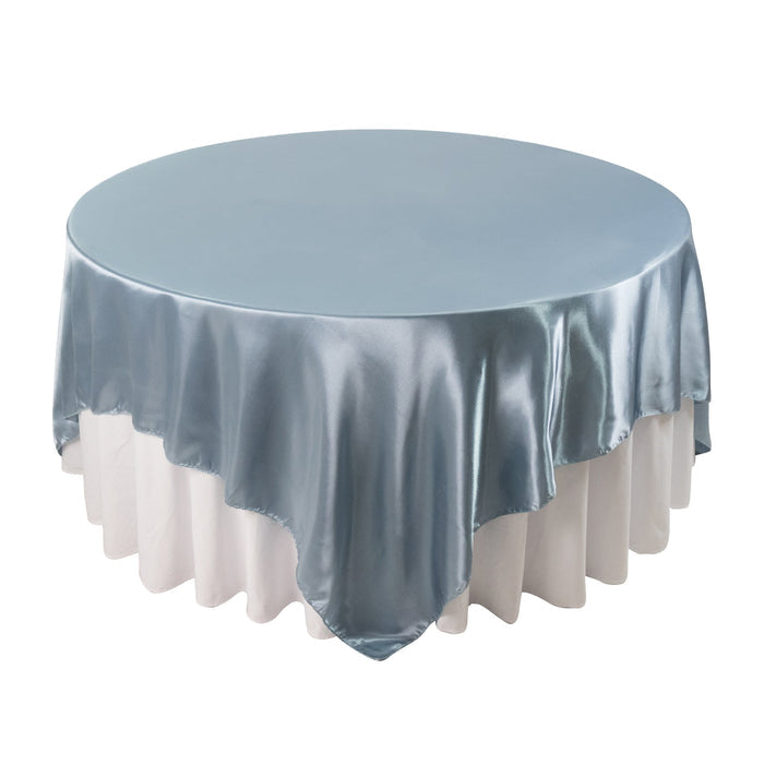 Round satin tablecloth in soft blue, elegantly draped over a white table.