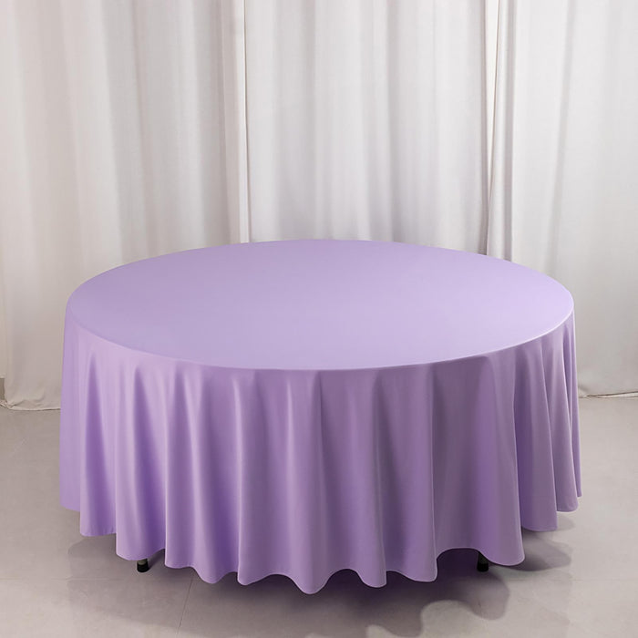 Round lavender tablecloth draped elegantly over a circular table.