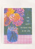 A card with image of flowers in a mason jar, text reads "I am so lucky to have you in my life".
