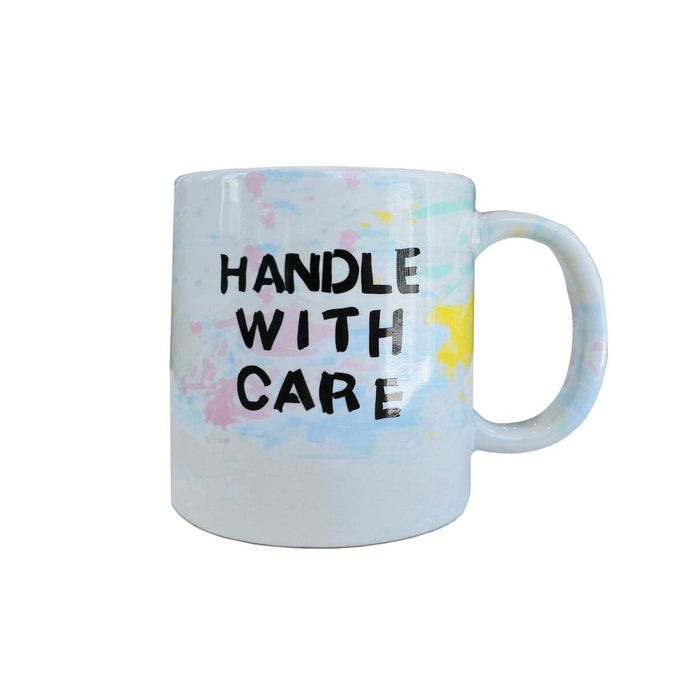 Mug with 'Handle with Care' text on a white background