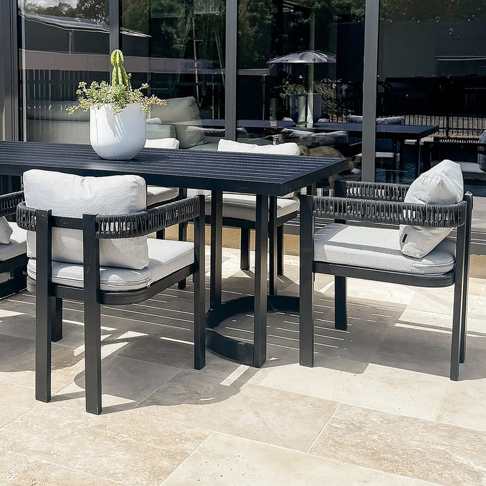 Modern outdoor dining set with table and four chairs on a patio