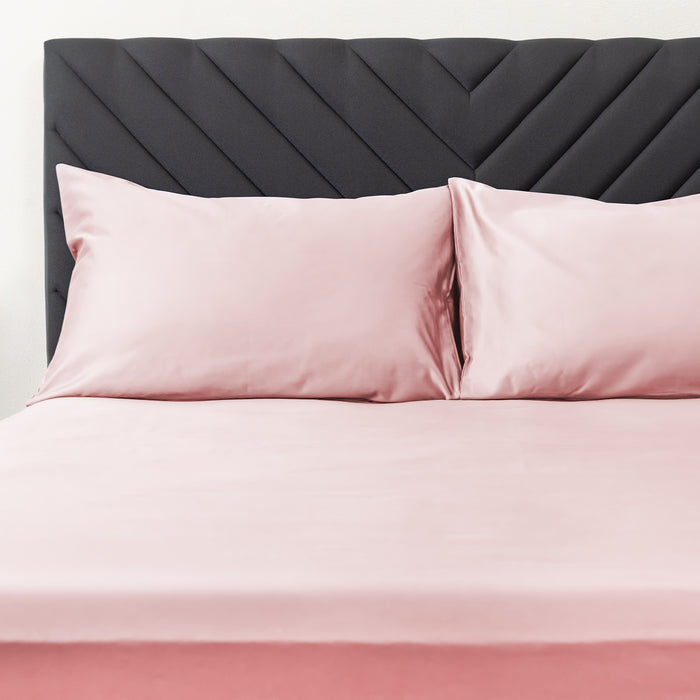 Wink Bed Linens 2 Piece Pillowcase Set in pink, shown in a room setting